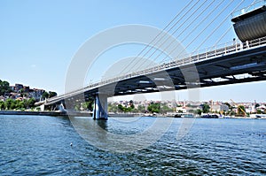 Panoramic view of the bridge over the strait. Metro bridge and coastline with ships and residential buildings.