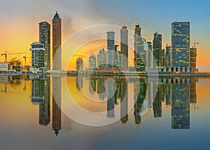 Panoramic view of Business bay and downtown area of Dubai, reflection in a river, UAE