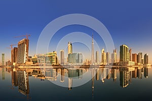 Panoramic view of Business bay and downtown area of Dubai, reflection in a river, UAE