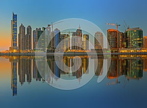 Panoramic view of Business bay and downtown area of Dubai, reflection in a river, UAE