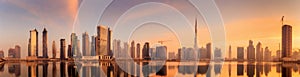 Panoramic view of Business bay and downtown area of Dubai, reflection in a river, UAE