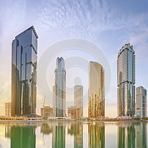 Panoramic view of Business bay and Lake Tower, reflection in a river, Dubai UAE