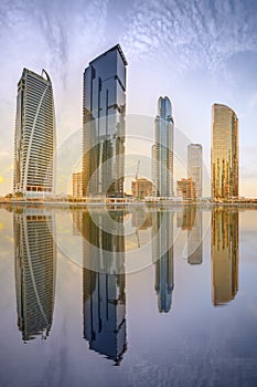 Panoramic view of Business bay and Lake Tower, reflection in a river, Dubai UAE