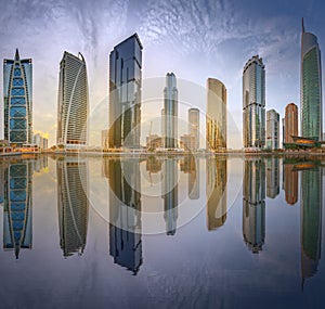 Panoramic view of Business bay and Lake Tower, reflection in a river, Dubai UAE