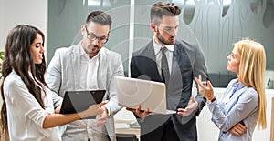 Panoramic view of business partners talking on meeting at office.