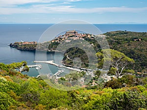Panoramic view of Capraia town and harbour with Elba, Italy
