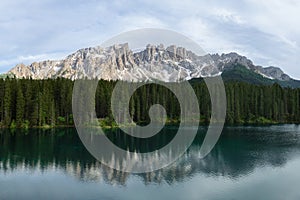 Panoramic view of Carezza Lake with reflecting in the water mount Latemar, Italy