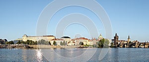 Panoramic view at Charles Bridge Prague Castle old town houses with red tegular roofs and broach tower and river Vltava Prague