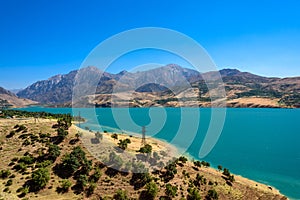 Panoramic view of Charvak Lake, a huge artificial lake-reservoir created by erecting a high stone dam on the Chirchiq River