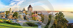 Panoramic view of Chateau Frontenac surrounded by greenery in Old Quebec, Canada at sunrise