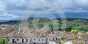 Panoramic view of Chinchon village, Community of Madrid, Castille-La Mancha, Spain. Dramatic stormy sky over suburban scenery