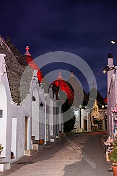 Panoramic view of the City of Alberobello with ancient traditional Italian Bluildings called Trulli at night