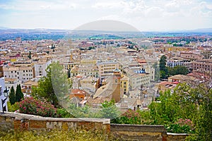 Panoramic view from the city elevated point on old town of Granada and mountains on horizon, Spain.