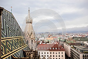 Panoramic view of city, roofs of houses from St. Stephen`s Cathedral. Famous ornately patterned, multi colored roof and north