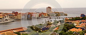 Panoramic view of the city from the top of Queen Juliana Bridge, with buildings and ships along St Anna Bay near Willemstad, C