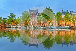 Panoramic view and cityscape of Amsterdam with boats, old buildings and Amstel river, Holland, Netherlands