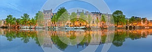 Panoramic view and cityscape of Amsterdam with boats, old buildings and Amstel river, Holland, Netherlands