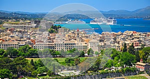 Panoramic view on classical Greek houses buildings architecture of Greece Corfu island capital Kerkyra, white cruise liner ship. G