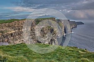 Panoramic view of the Cliffs of Moher, Ireland. Cliffs of Moher during sunset. Coastline in Ireland with huge cliffs