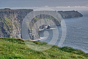 Panoramic view of the Cliffs of Moher, Ireland. Cliffs of Moher during sunset. Coastline in Ireland with huge cliffs