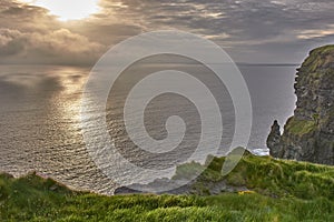 Panoramic view of the Cliffs of Moher, Ireland. Cliffs of Moher during sunset. Coastline in Ireland with huge cliffs