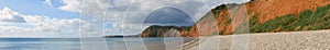 A Panoramic view of the cliffs at Sidmouth in Devon, showing the stone shore and the oxidised cliffs in the bay photo