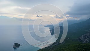Panoramic view of coastal landscape with mountainous background and calm sea