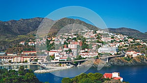 A panoramic view of a coastal port city from a mountain summit, where the convergence of land and sea creates a mesmerizing specta