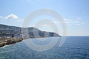 Panoramic view of coastline and beach with blue sky, luxury resort and bay with yachts, Nice port, France