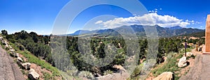 An panoramic view of Colorado Springs, Colorado\'s Valley of the Gods Park, with Pikes Peak nestled amidst the range.