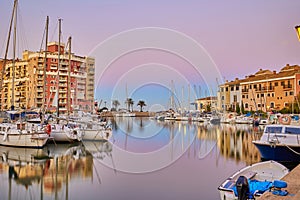 Panoramic view of colorful houses and moored yachts in Port Saplaya