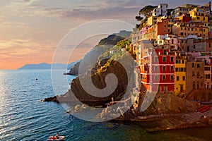 Panoramic view of colorful Village Riomaggiore in Cinque Terre during sunset, Liguria, Italy