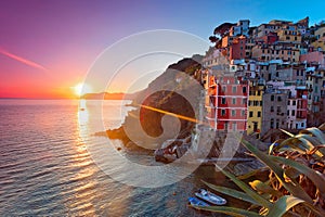 Panoramic view of colorful Village Riomaggiore in Cinque Terre during sunset, Liguria, Italy