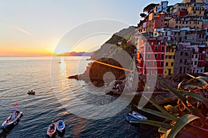 Panoramic view of colorful Village Riomaggiore in Cinque Terre during sunset, Liguria, Italy