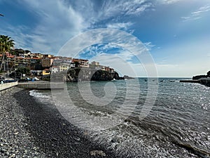 Panoramic view of colourful houses build on steep cliffs in fishermen village of Camara de Lobos on Madeira island