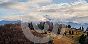 Panoramic view of countryside landscape with mountains in the background in autumn