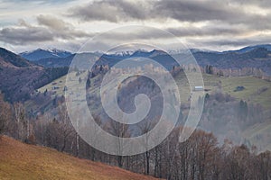 Panoramic view of countryside landscape with mountains in the background in the stormy daylight