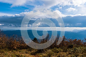 The panoramic view of CÃ´te d`Azur Alps mountains under the cloudy sky and the Meditarrenean sea coastline