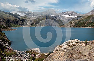 Panoramic View of a dammed lake high in the alpine peaks of Switzerland.