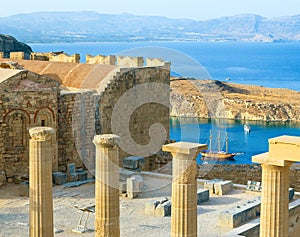 Panoramic view of Doris Temple of Athena Lindia, medieval castle on Acropolis of Lindos with blue bay beneath, Rhodes