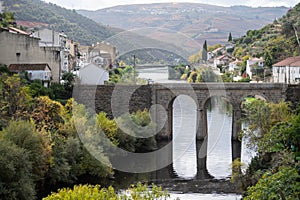 Panoramic view on Douro river valley and colorful hilly stair step terraced vineyards in autumn, wine making industry in Portugal