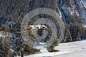 Panoramic view down an alpine mountain valley with hotel