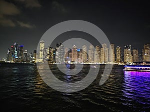 Panoramic view of Dubai Creek and night city skyline, United Arab Emirates concept