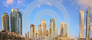 Panoramic view of Dubai Marina bay with yacht and cloudy sky, Dubai, UAE