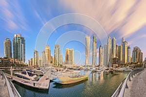 Panoramic view of Dubai Marina bay with yacht and cloudy sky, Dubai, UAE