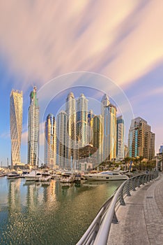 Panoramic view of Dubai Marina bay with yacht and cloudy sky, Dubai, UAE