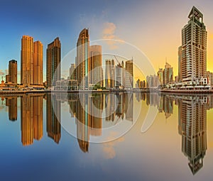 Panoramic view of Dubai Marina bay with yacht and cloudy sky, Dubai, UAE