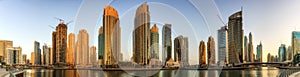 Panoramic view of Dubai Marina bay with yacht and cloudy sky, Dubai, UAE