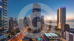 Panoramic view of the Dubai Marina and JBR area and the famous Ferris Wheel aerial day to night