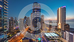 Panoramic view of the Dubai Marina and JBR area and the famous Ferris Wheel aerial day to night timelapse